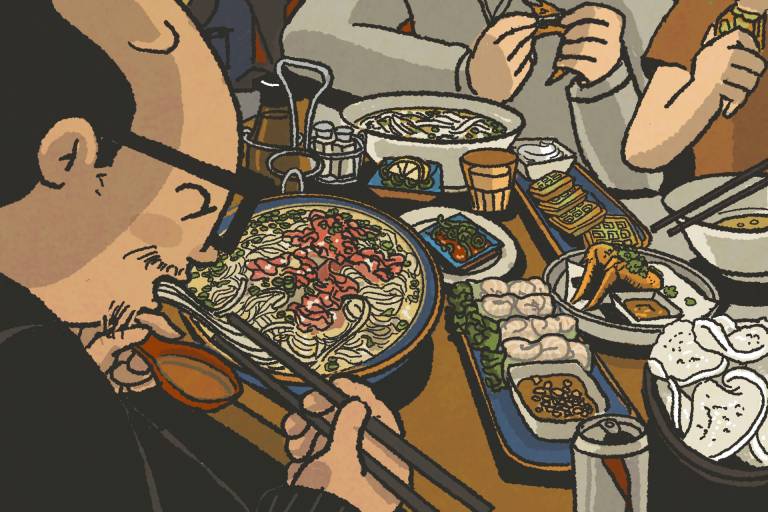 A man devouring a bowl of beef pho.