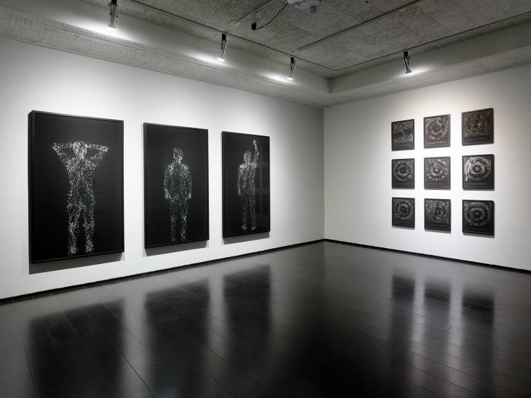 gallery with framed black and white photographs on walls