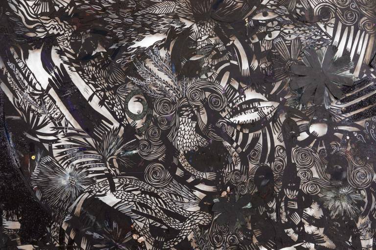 close-up of cut black paper with dense imagery