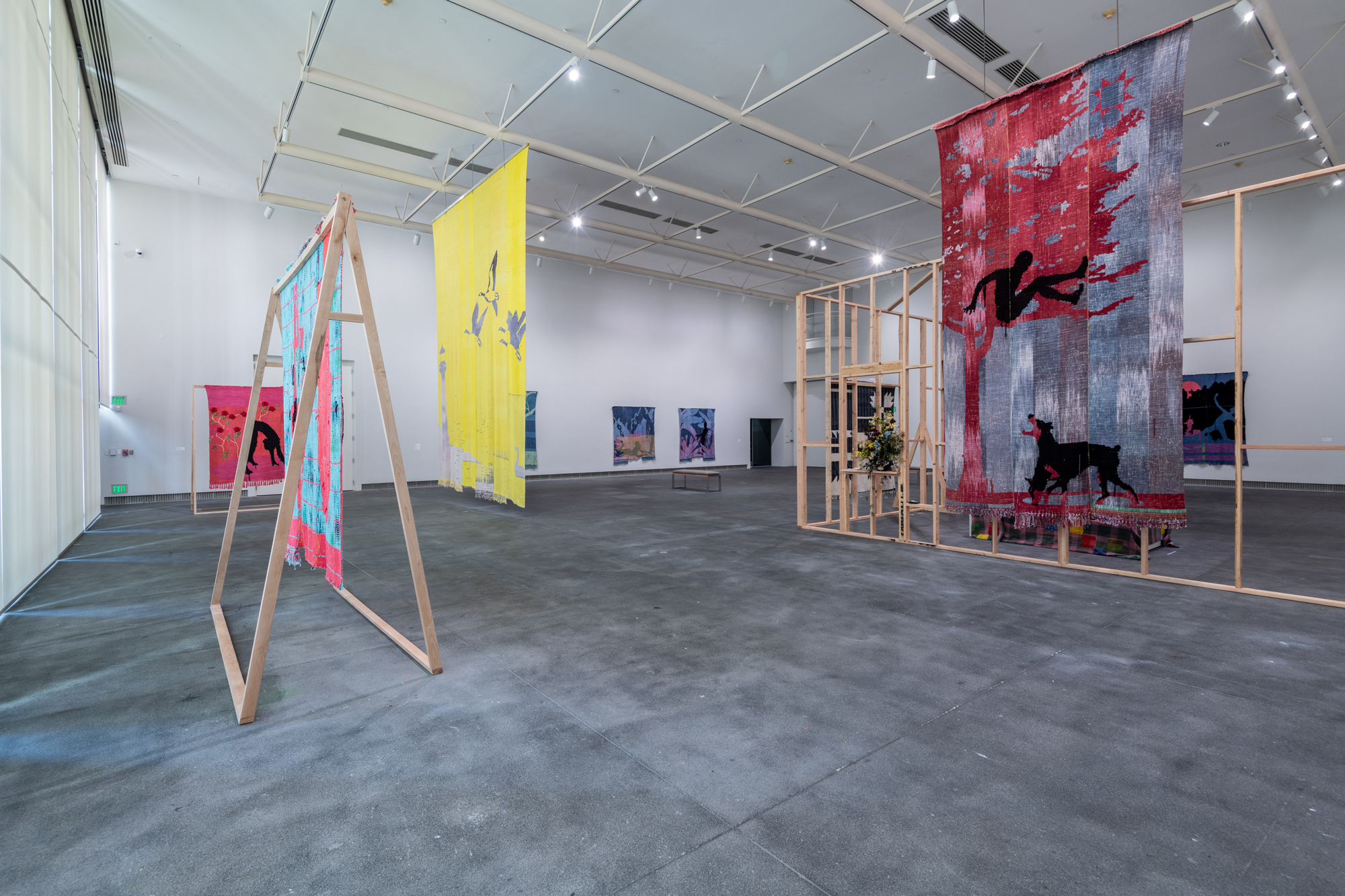 gallery view with large hanging textiles