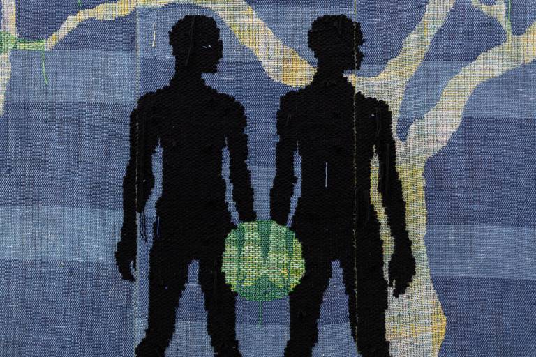 two black silhouettes' hands touch and green glow forms