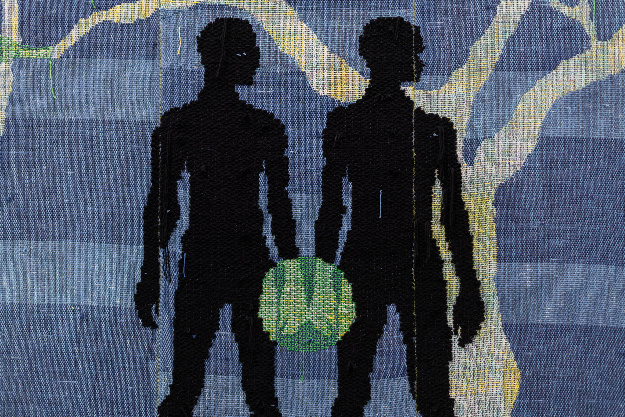 two black silhouettes' hands touch and green glow forms