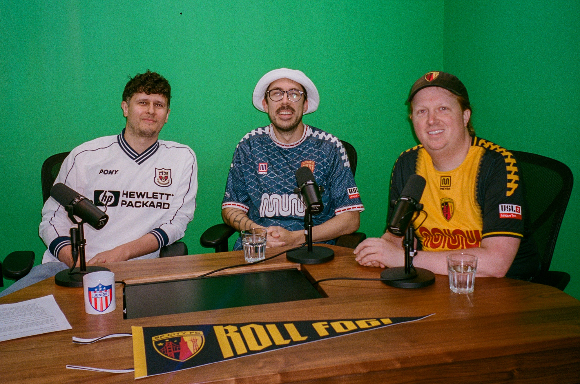 three men in soccer jerseys against green screen