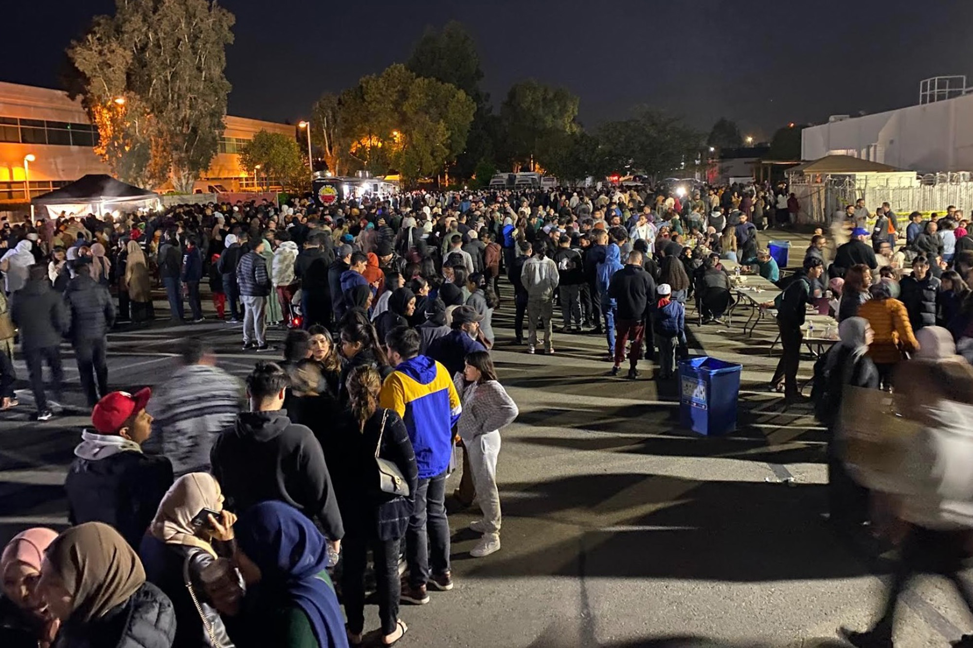 A crowded food festival at night.