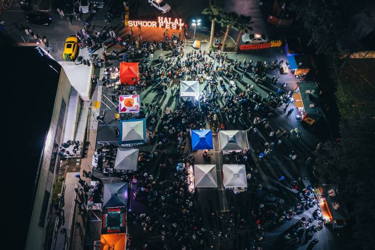 Overhead drone photo of a crowded festival at night.
