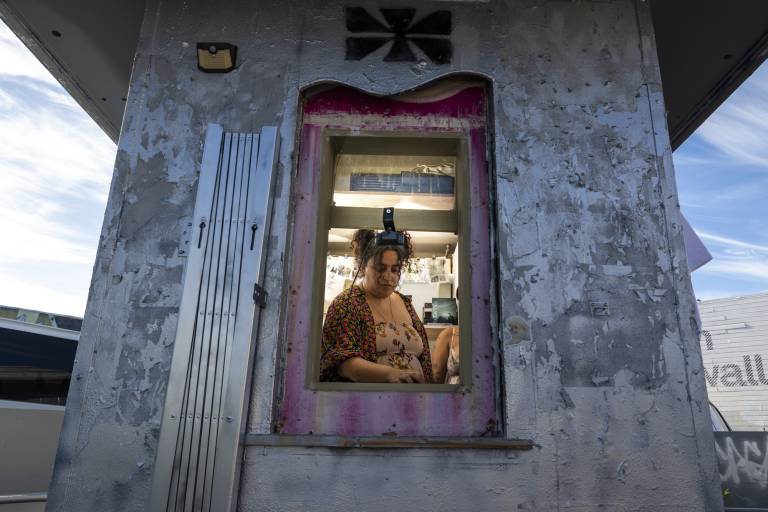 person seen through window inside hut