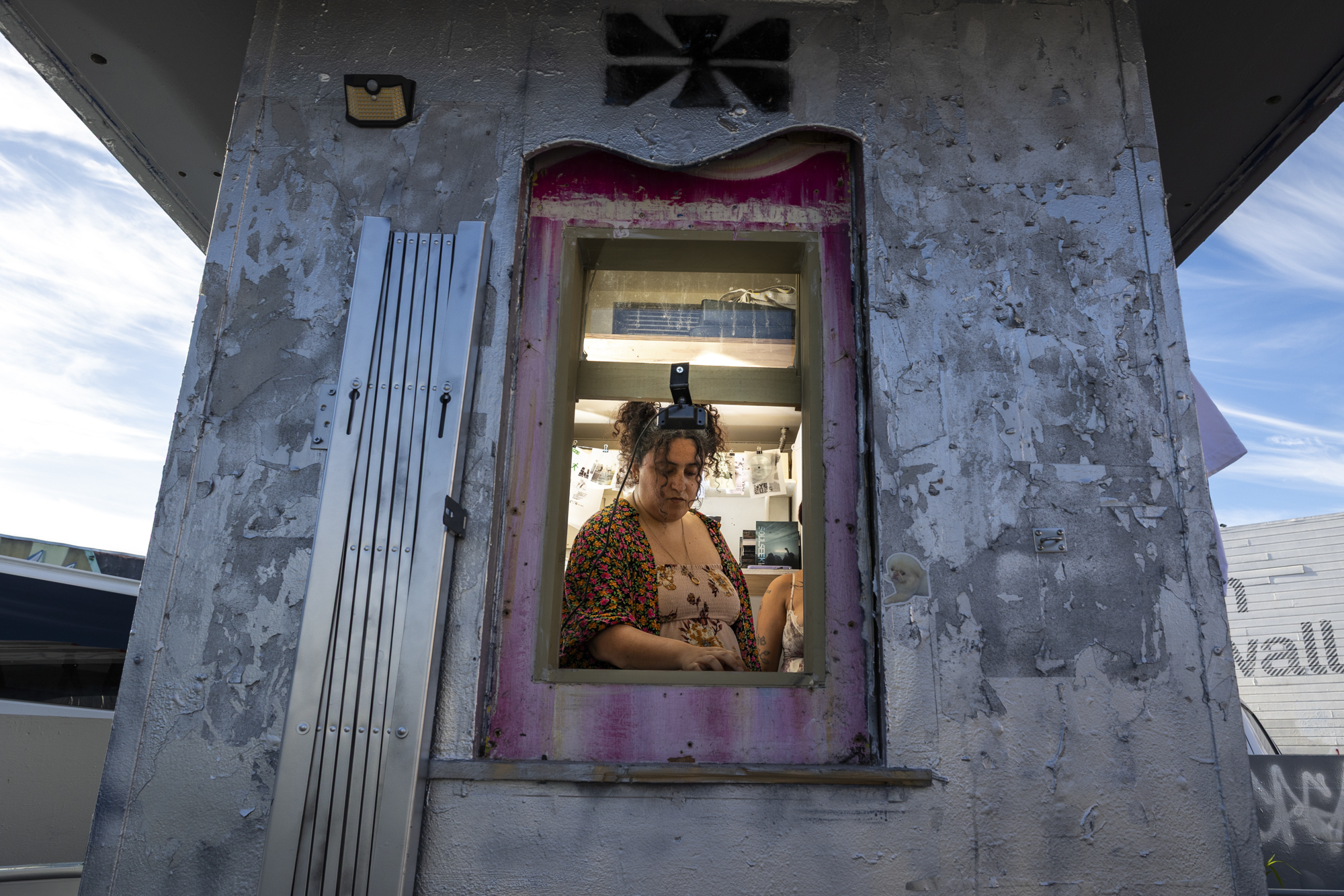 person seen through window inside hut