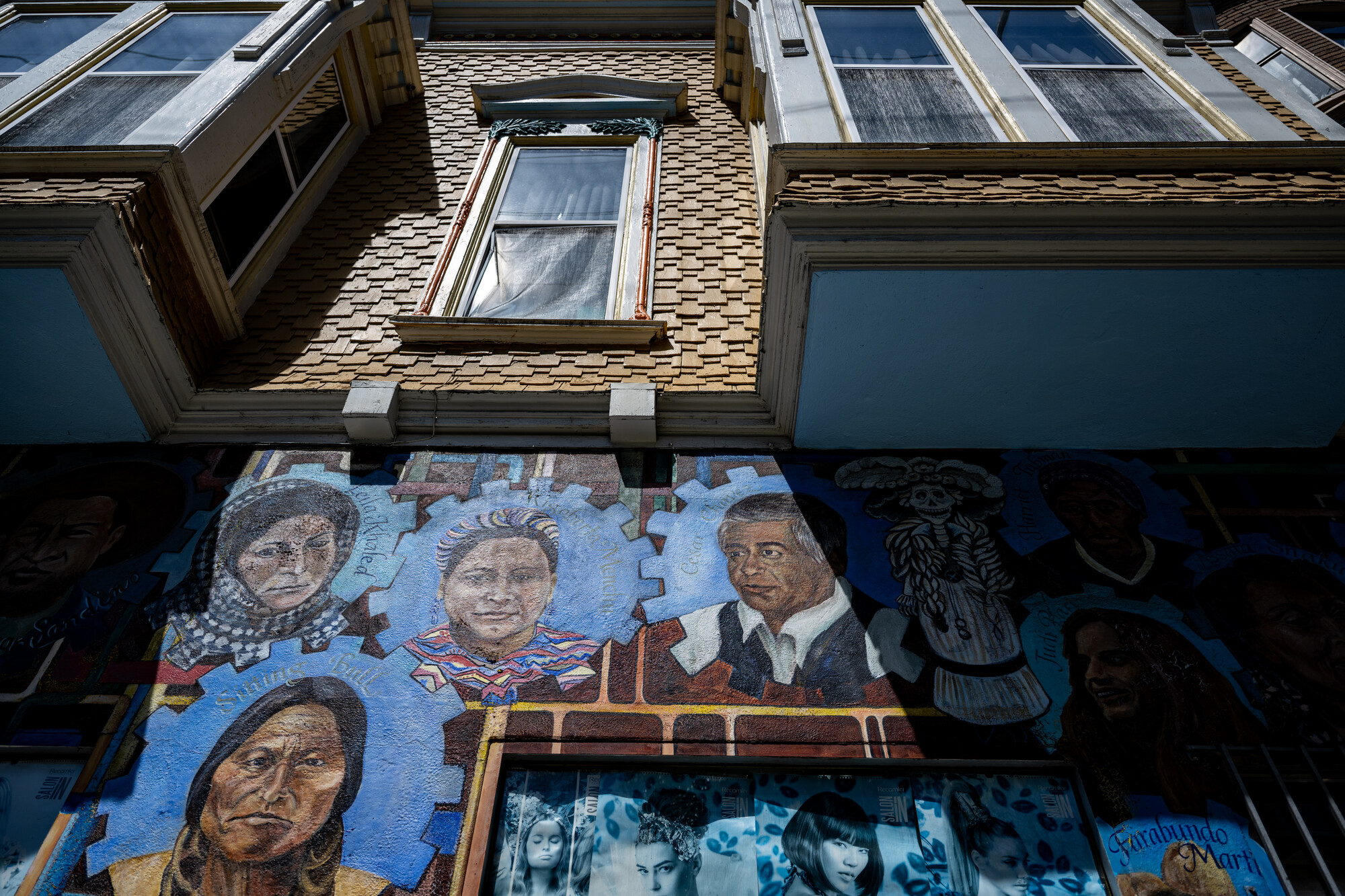 painted faces on side of building