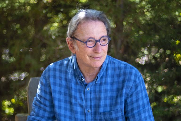 A man in blue shirt looks to the right