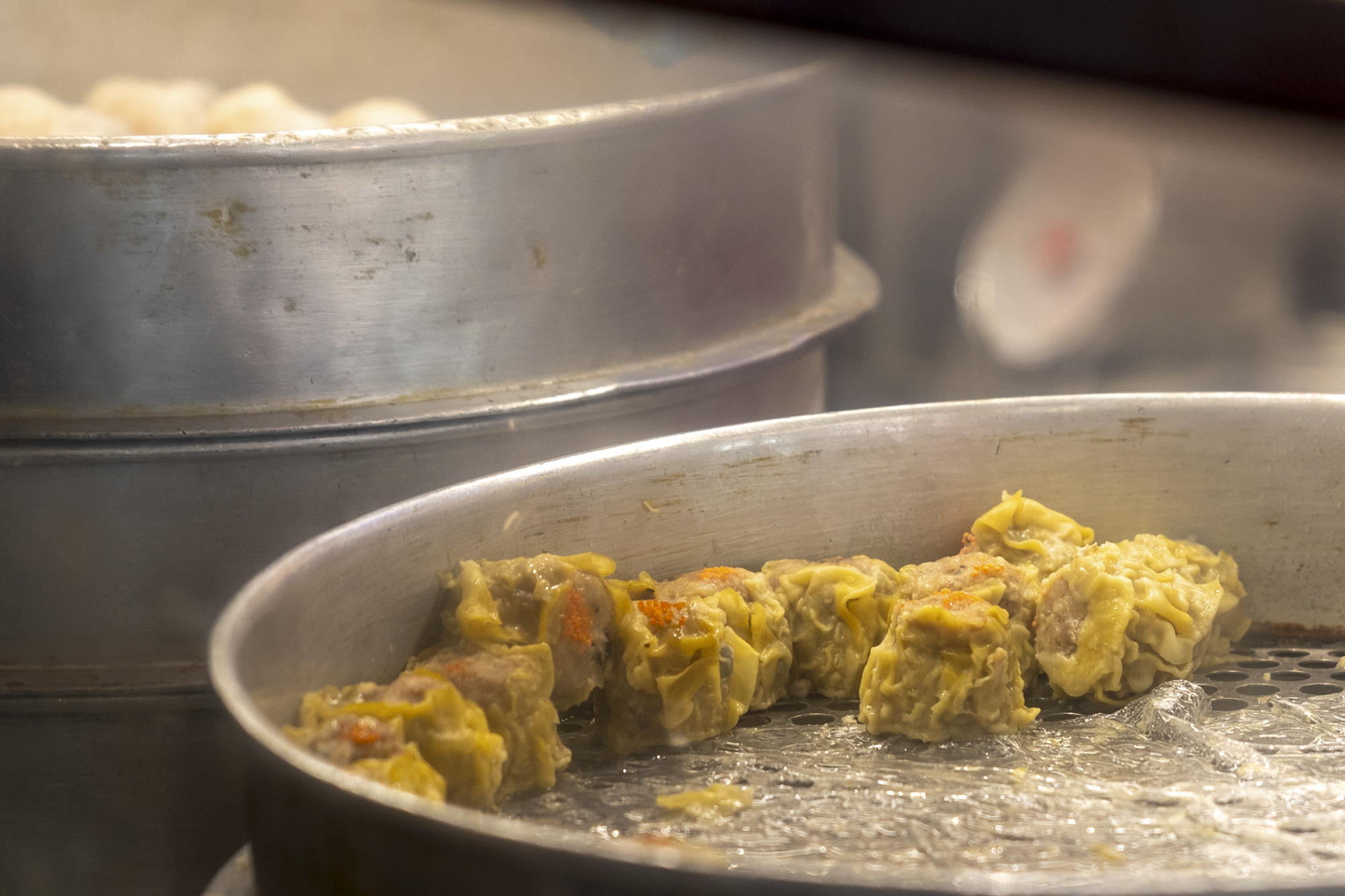 Siu mai dumplings in a metal steamer.