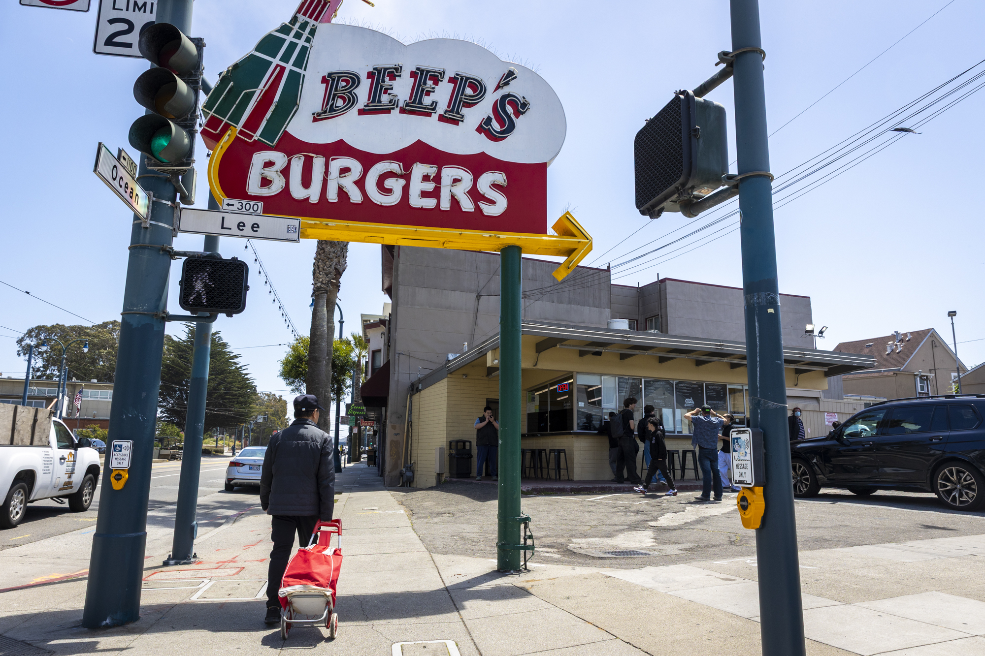 Exterior of a burger restaurant, with a big retro-style "Beep's Burgers" sign.