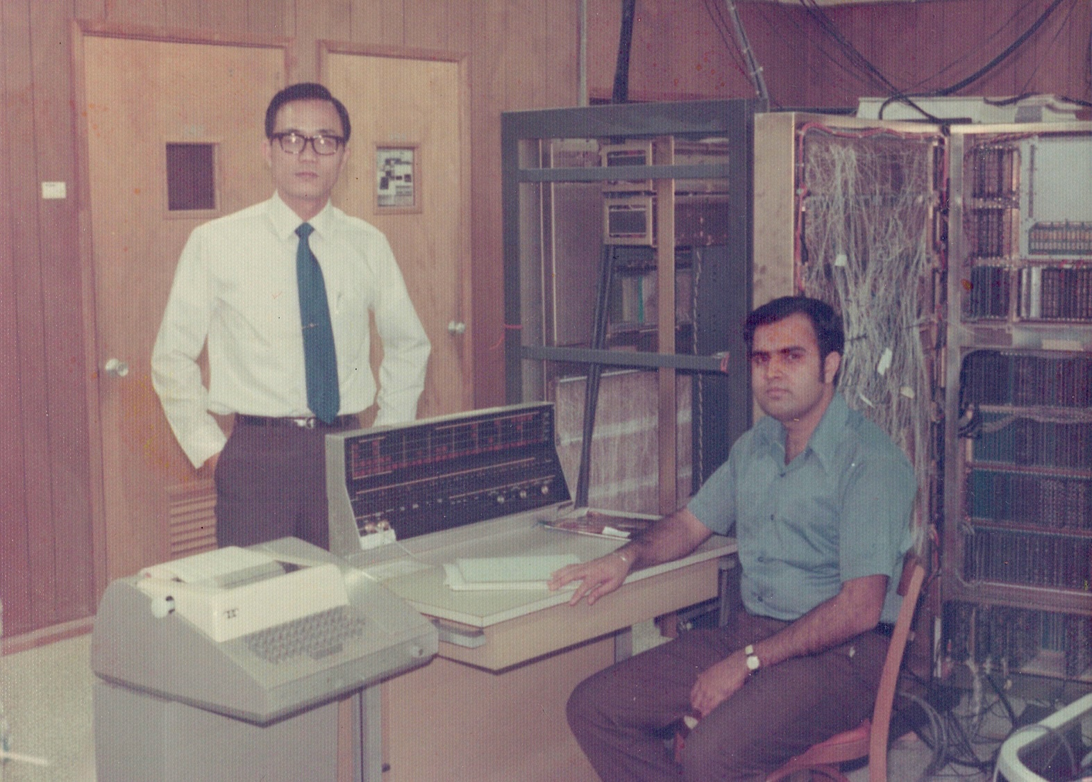 Asian man and South Asian man in room filled with computers