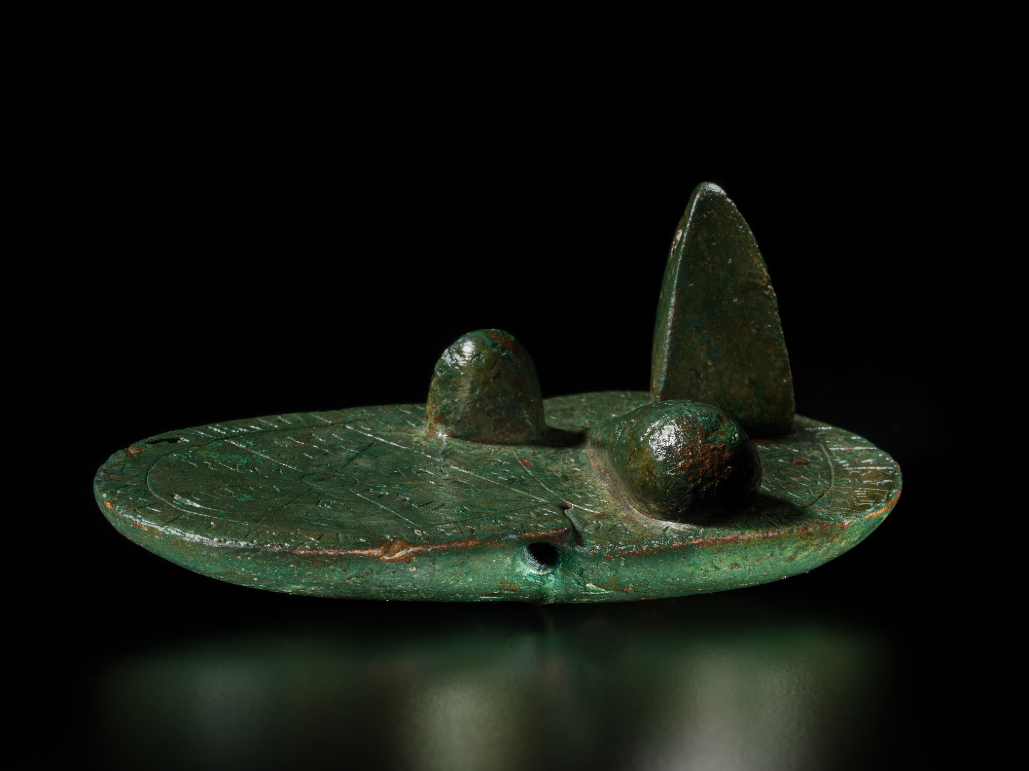 bronze object covered in inscriptions