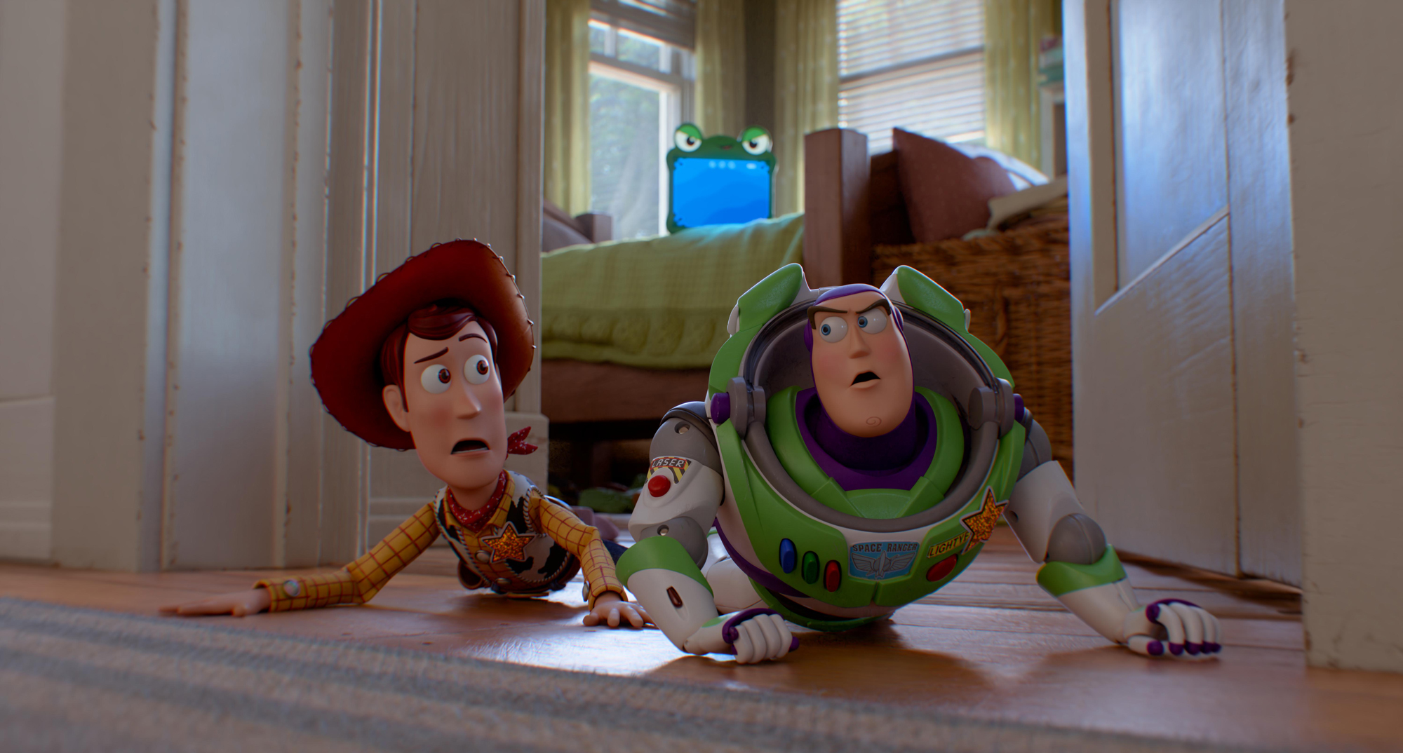 toy cowboy and toy astronaut crawl on flood of child's bedroom looking anxious