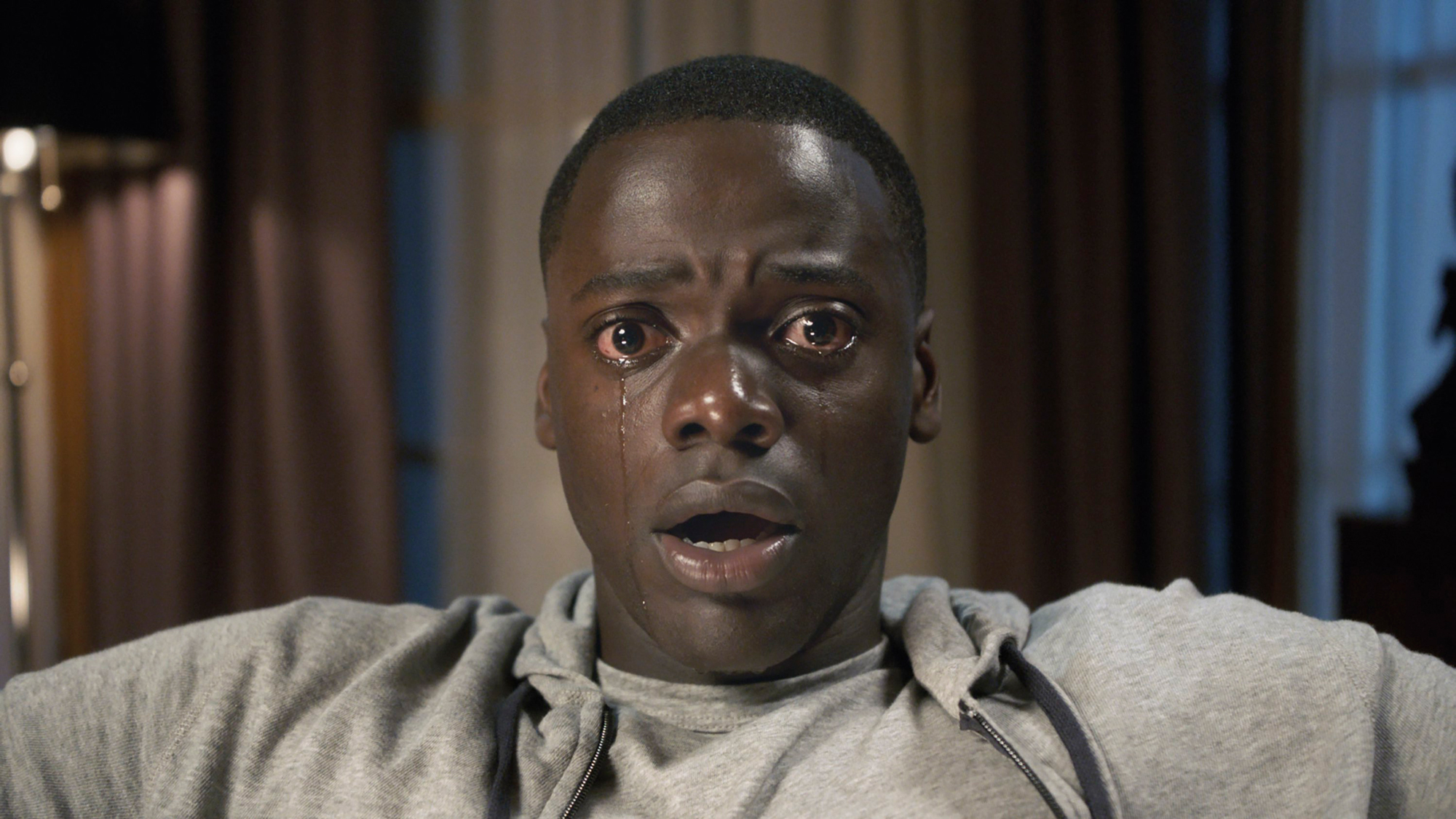 Black man frozen in terror with tears in eyes