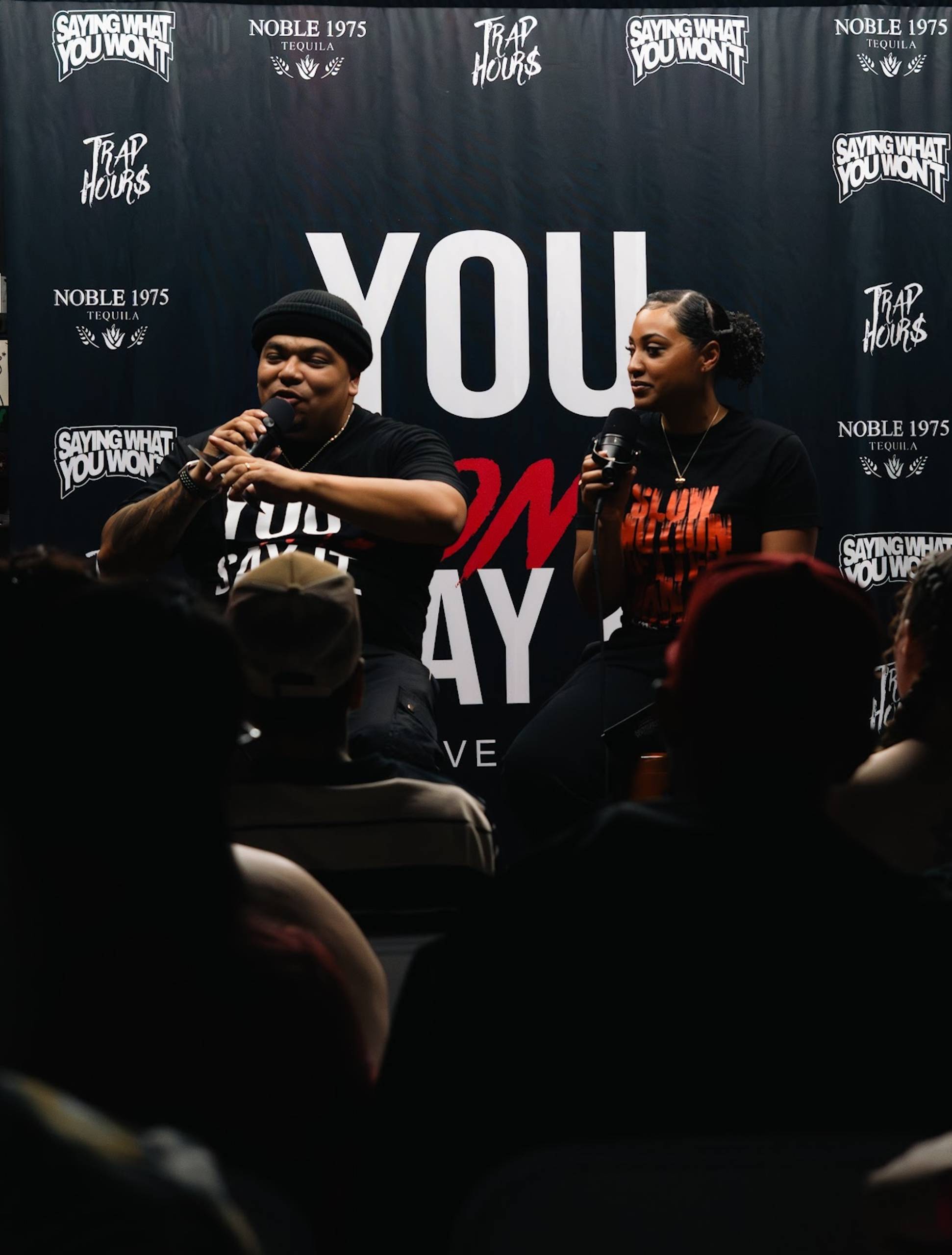Two people hosting an event on stage