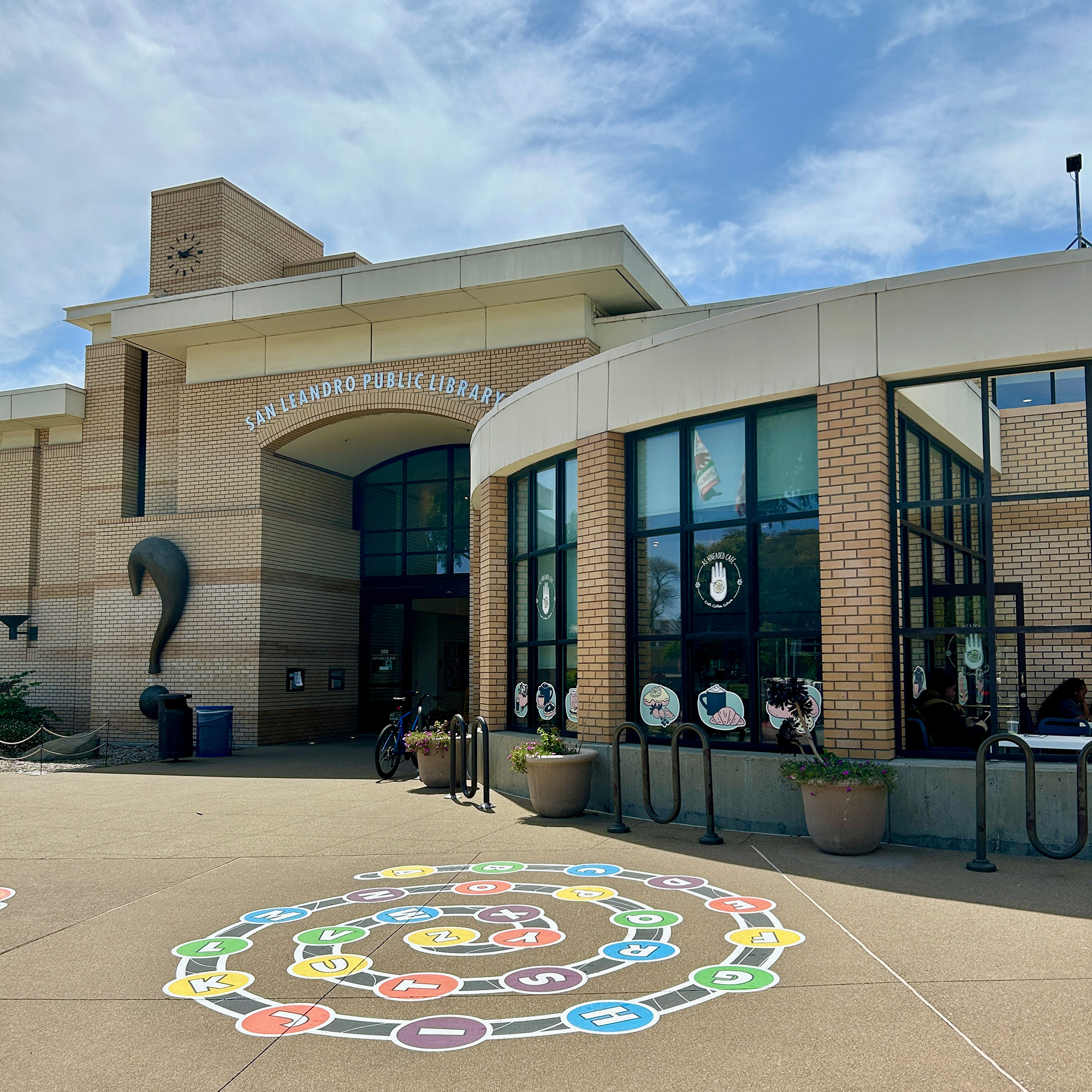 Exterior of a library with a cafe space in front.