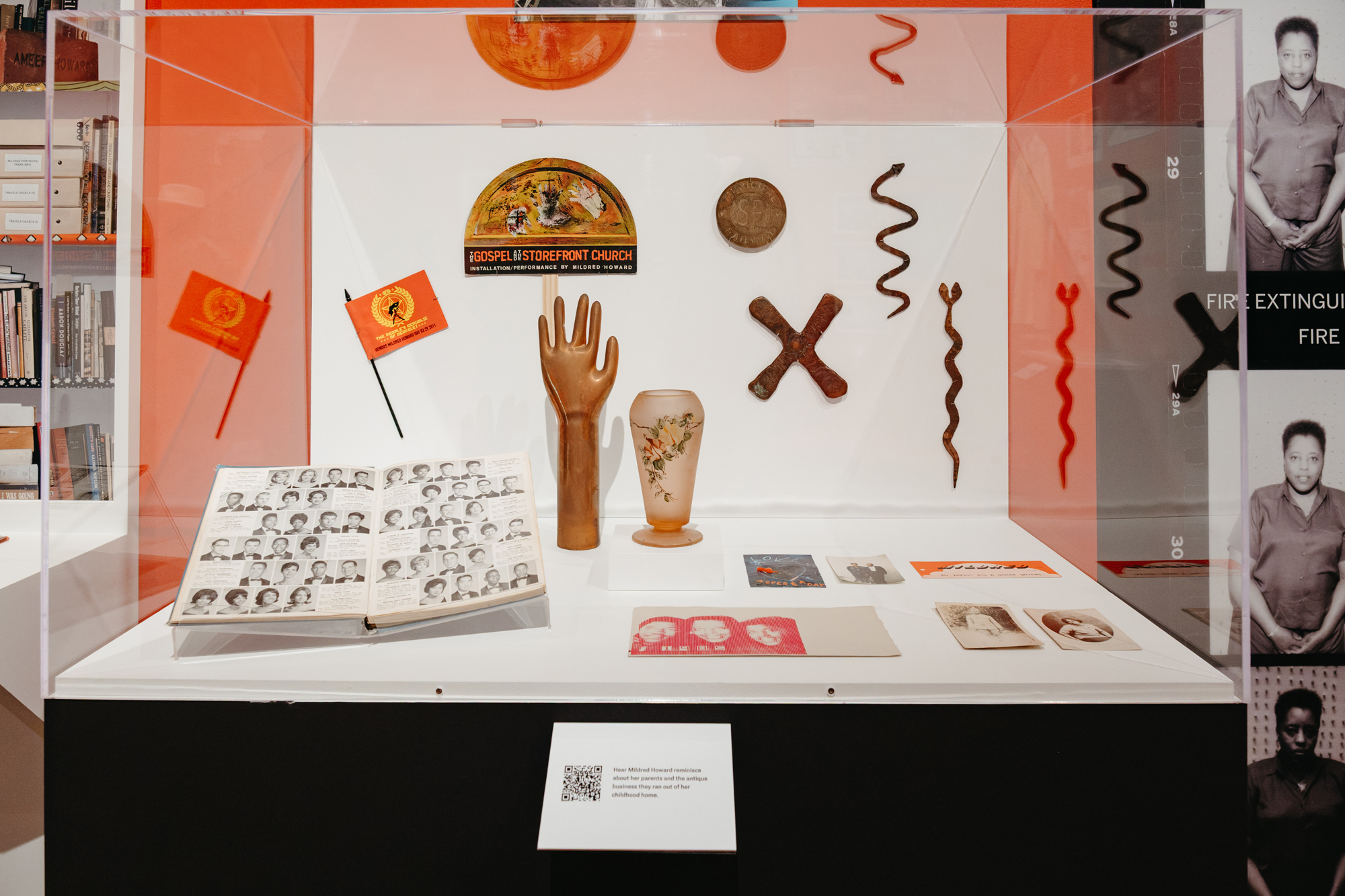 vitrine filled with yearbook, cards, small objects and photographs