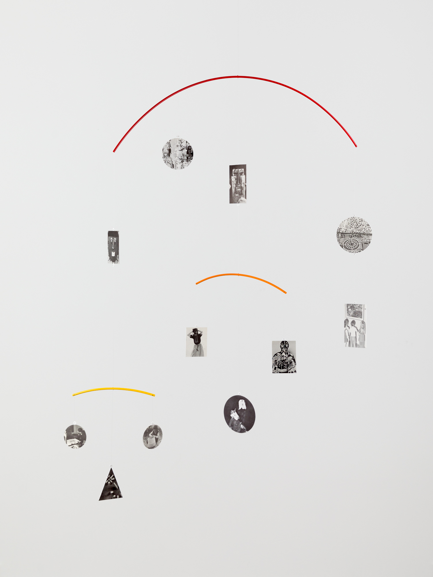 mobile of hanging shaped metal with images printed on them