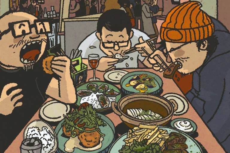 Three men at a restaurant hunched over a huge spread of Vietnamese dishes.