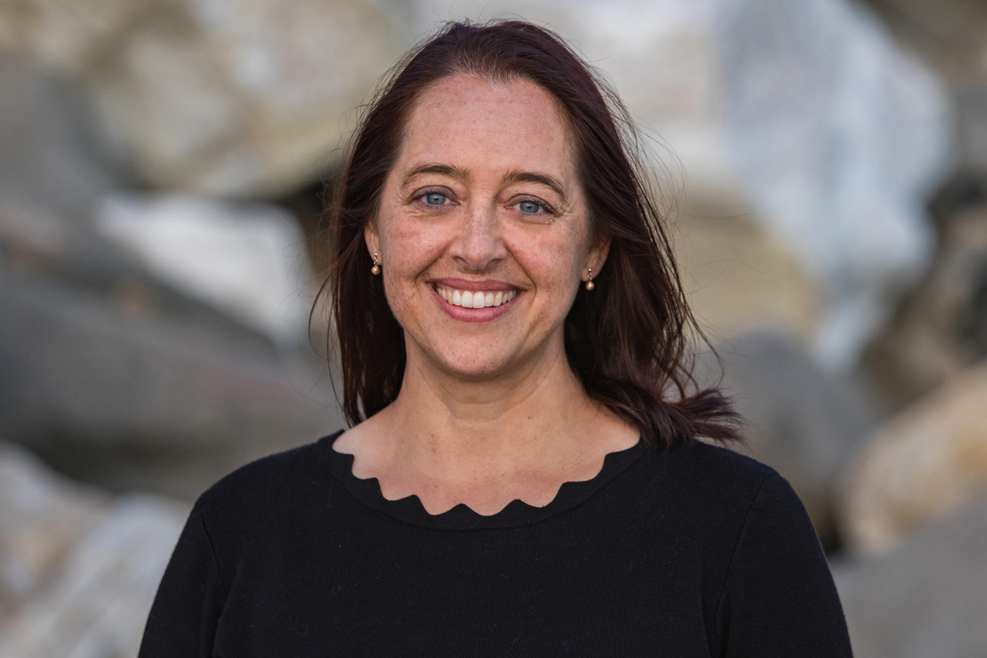smiling white woman with shoulder-length brown hair