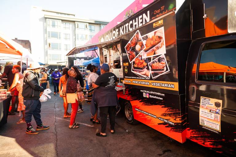 Customers lined up to buy food from the Jollof Kitchen food truck.