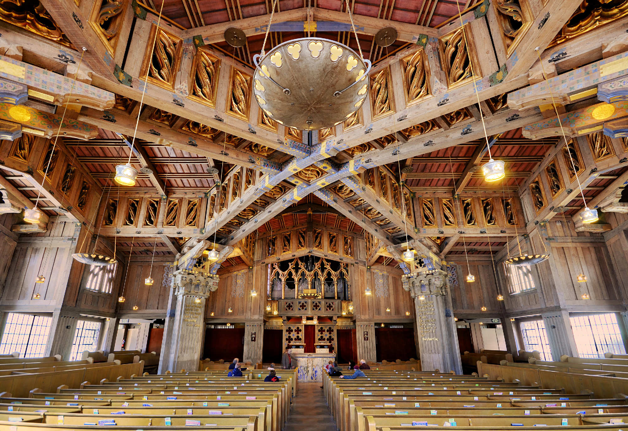 craftsman interior of church with pews and ornate wood ceiling