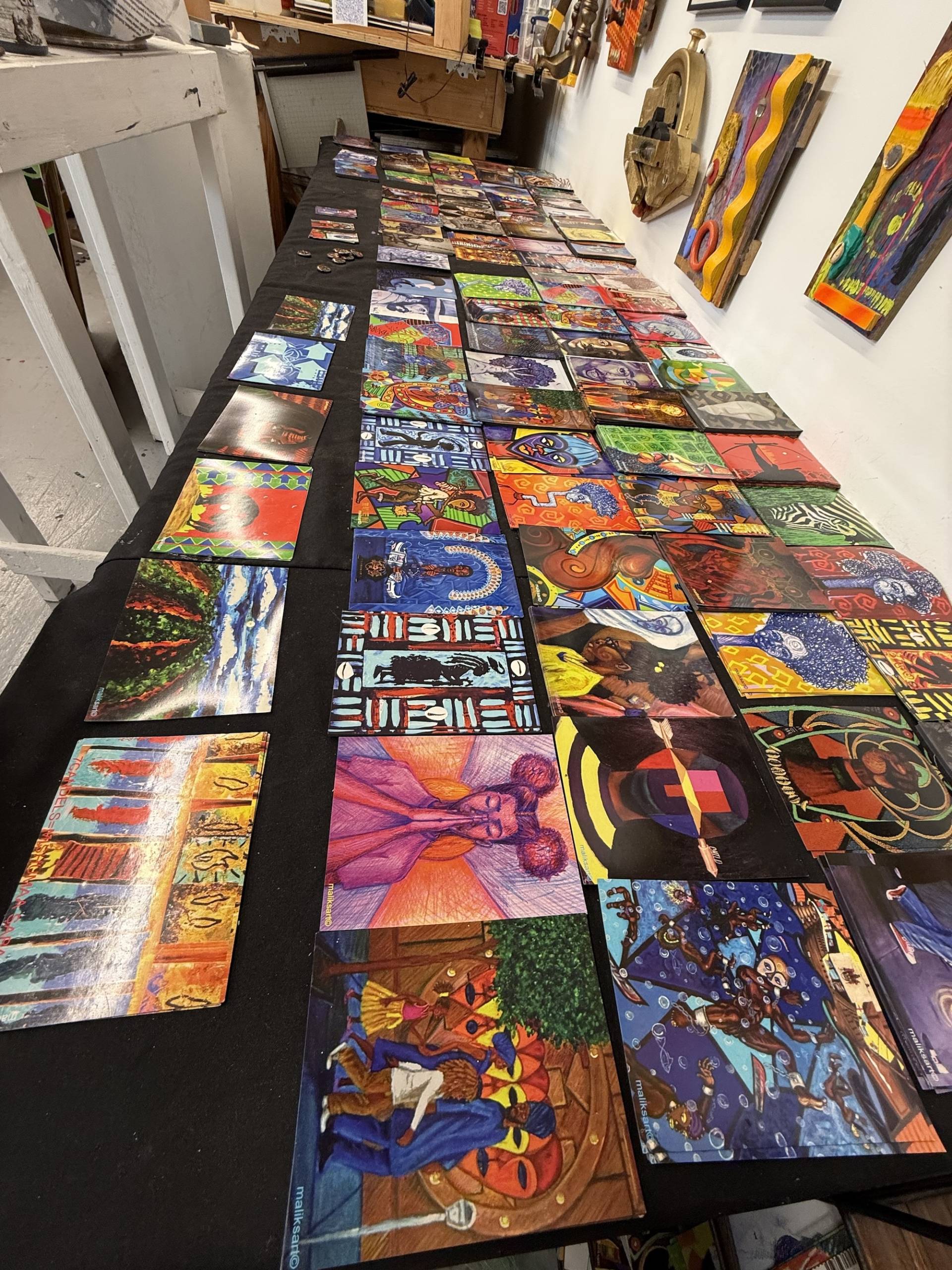 A table full of small painted art pieces.