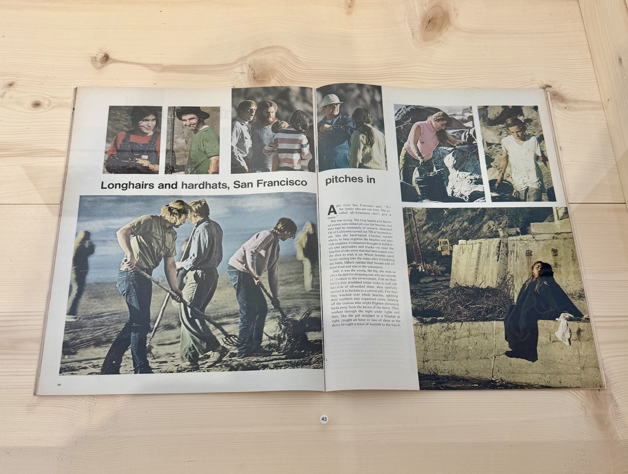 open spread of magazine with images of people cleaning oily straw on beach