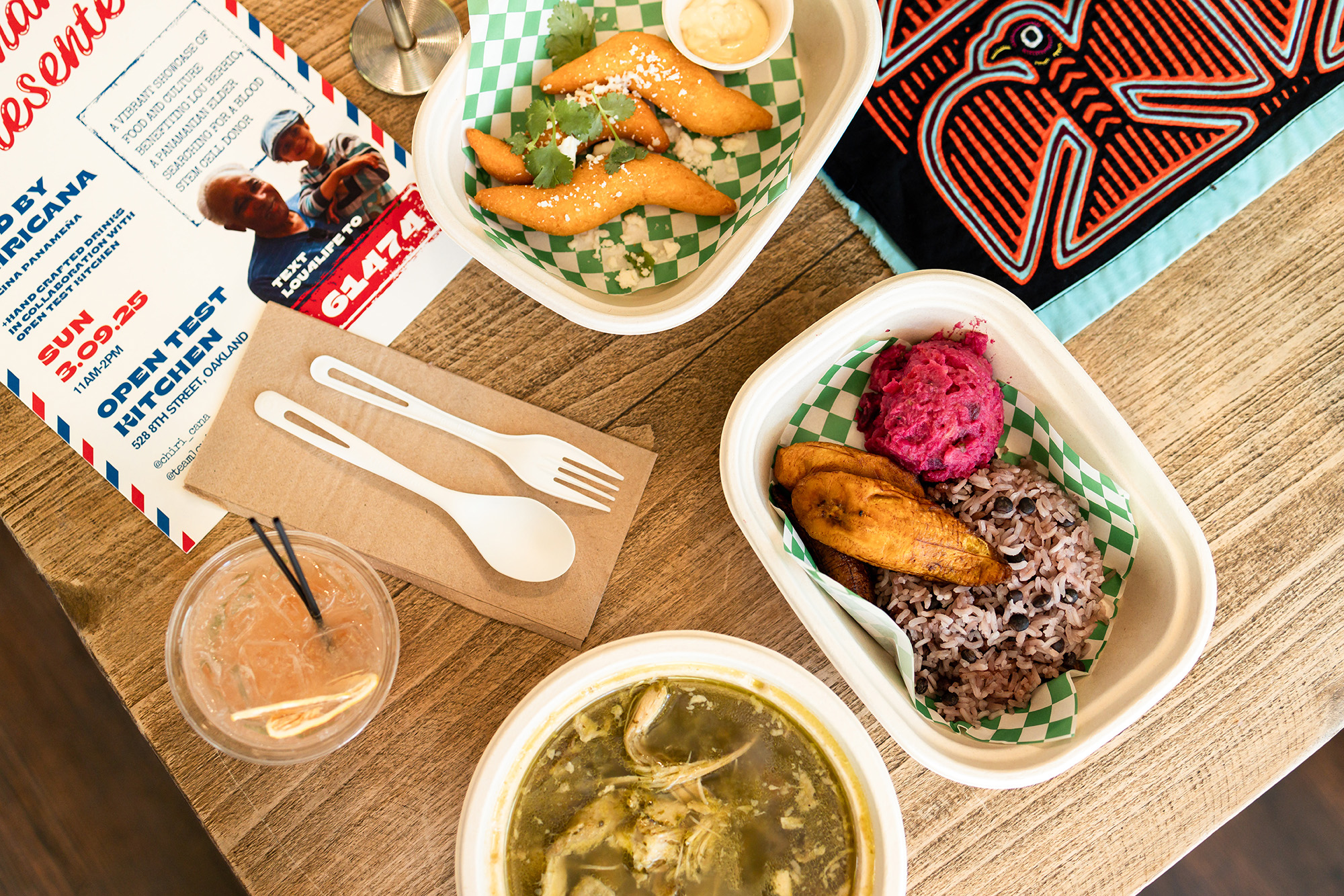 Overhead view of a spread of Panamanian dishes, including corn cheese fritters, rice and beans, and a beet salad.