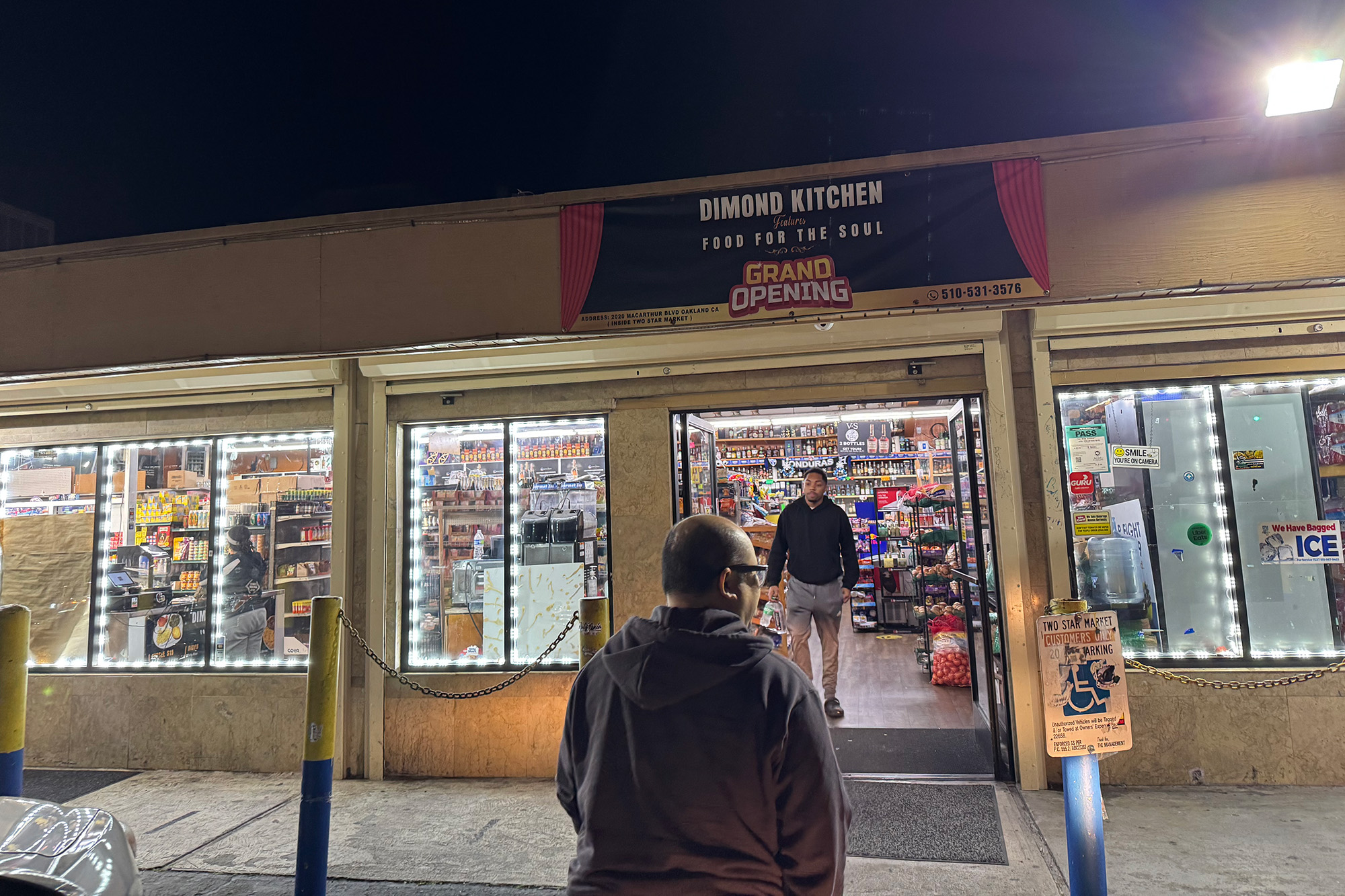 Exterior of a convenience store lit up at night.