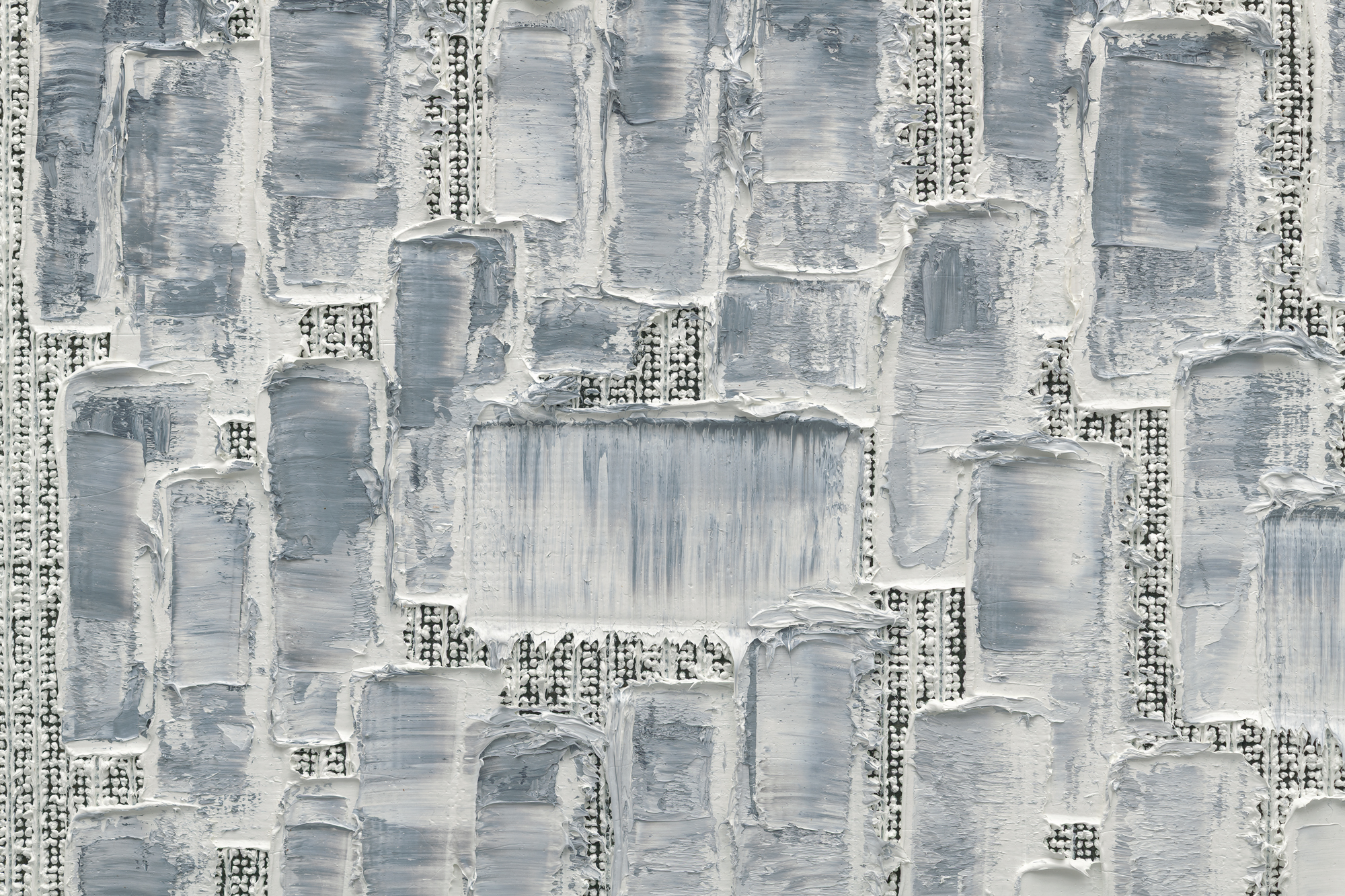 close-up of thick white and gray paint applied in textured blocks