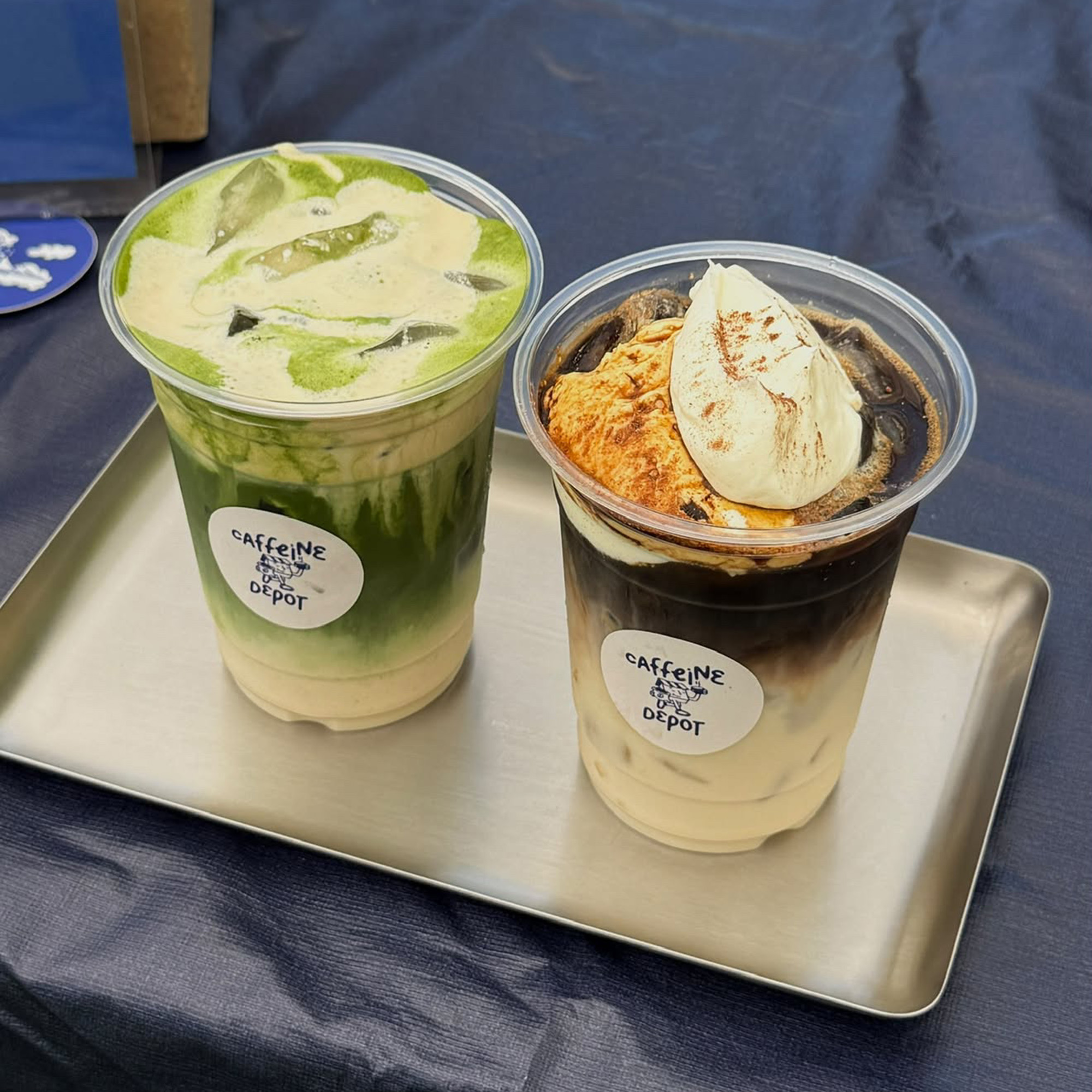 A matcha drink and a coffee drink, both mixed with creamy foam.