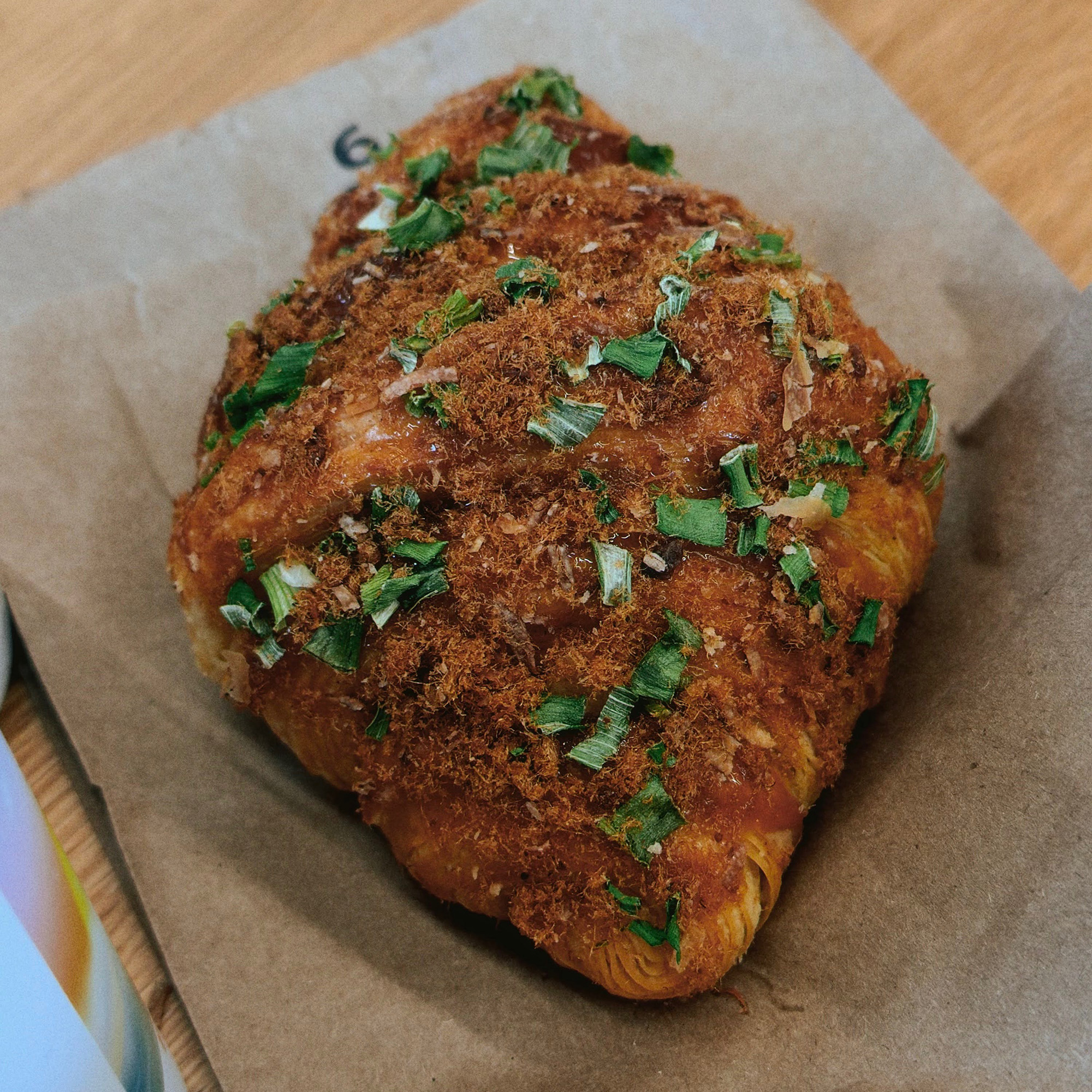 Croissant topped with pork floss and scallions
