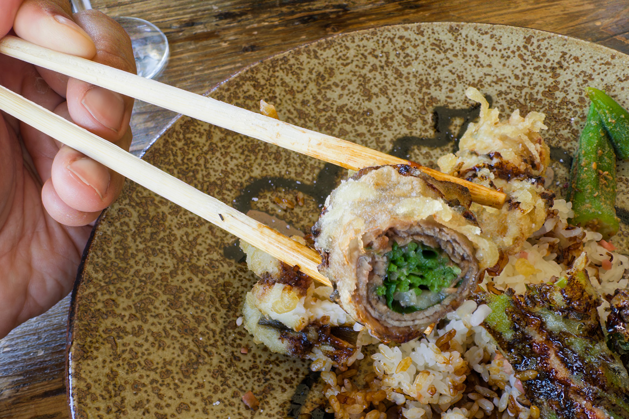 Close-up of the cross section of beef-wrapped pea shoot tempura.
