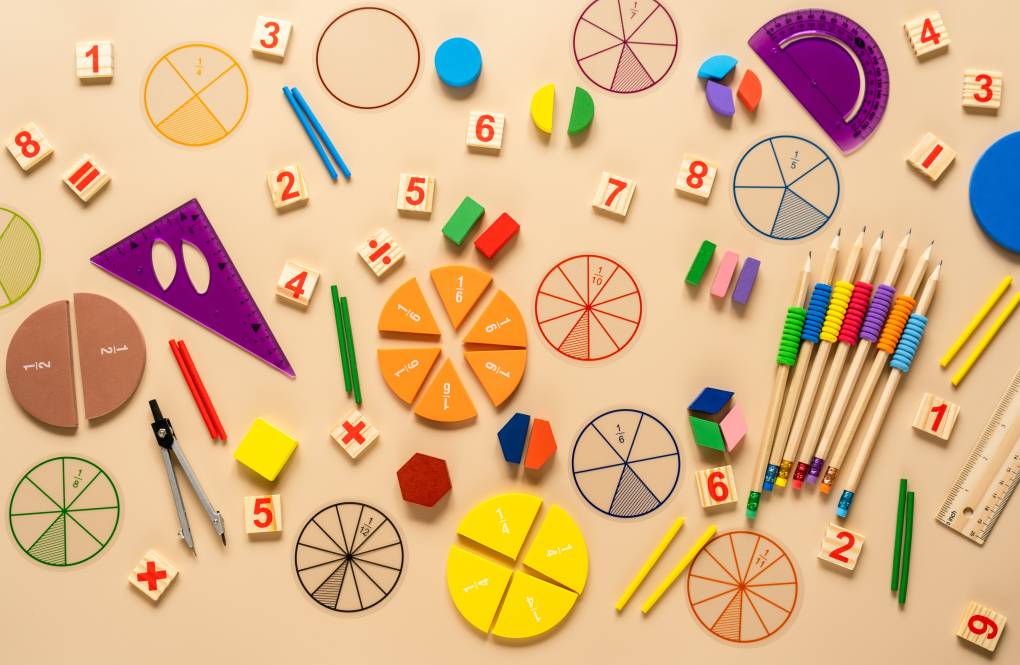 Wooden toy blocks. School supplies, math fractions, pencils, numbers, on beige background
