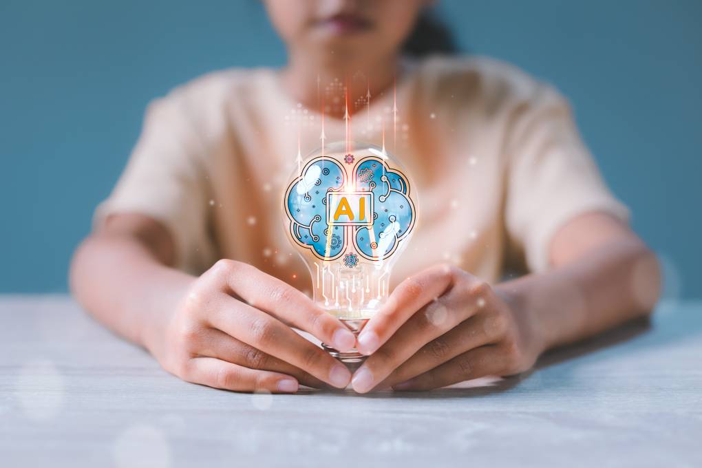 Girl holding light bulb with the letters "AI" and a brain illustrated on it.
