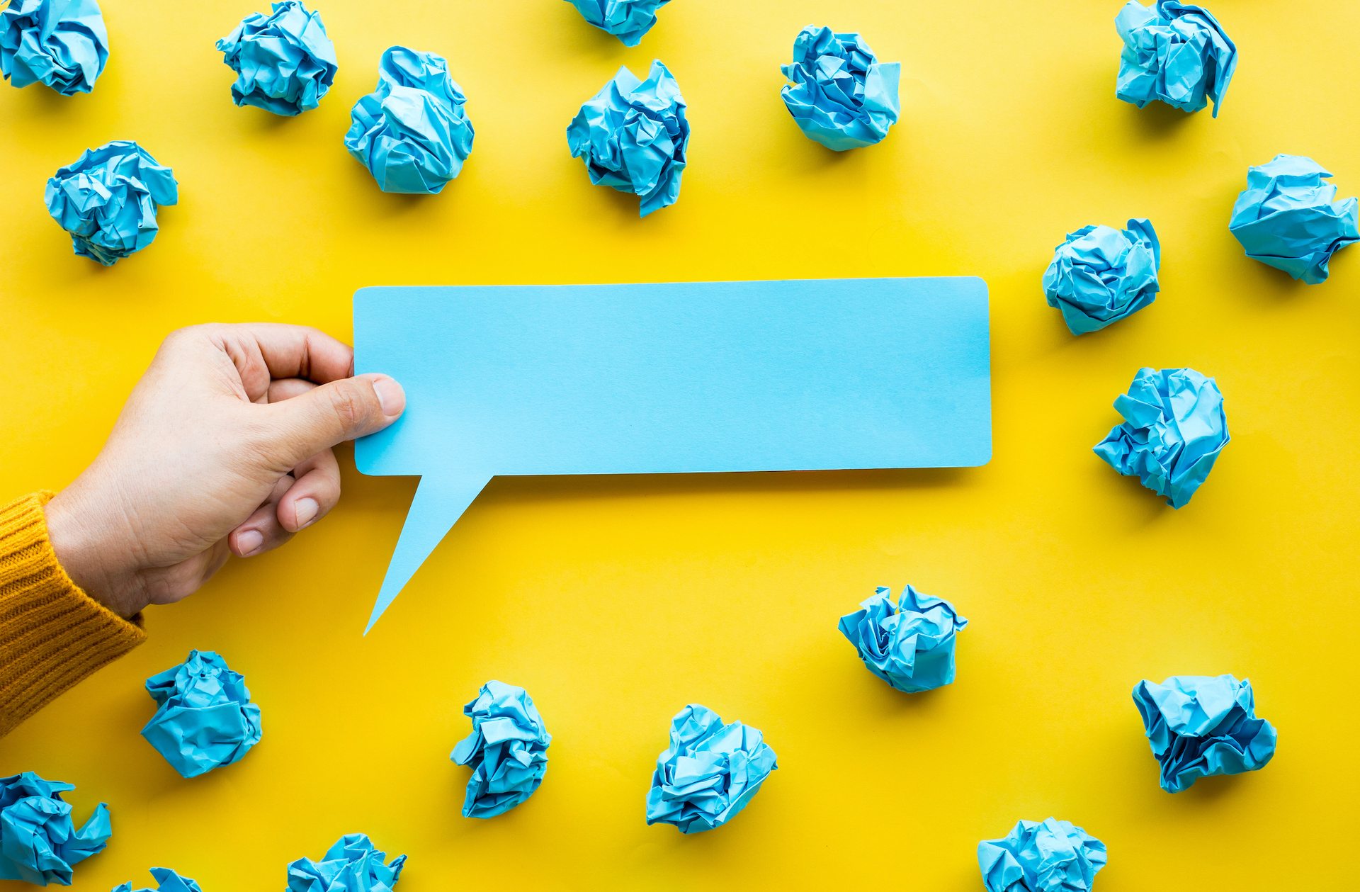 person's hand holding bubble paper and paper crumpled ball