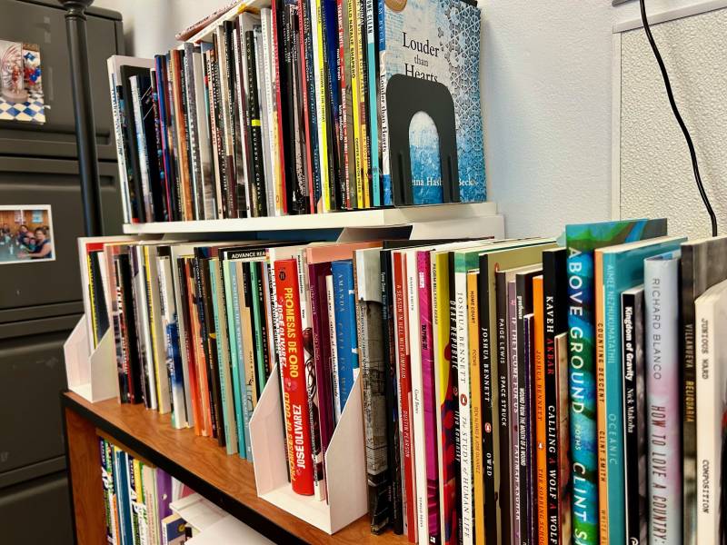 two bookshelves filled with books against a wall