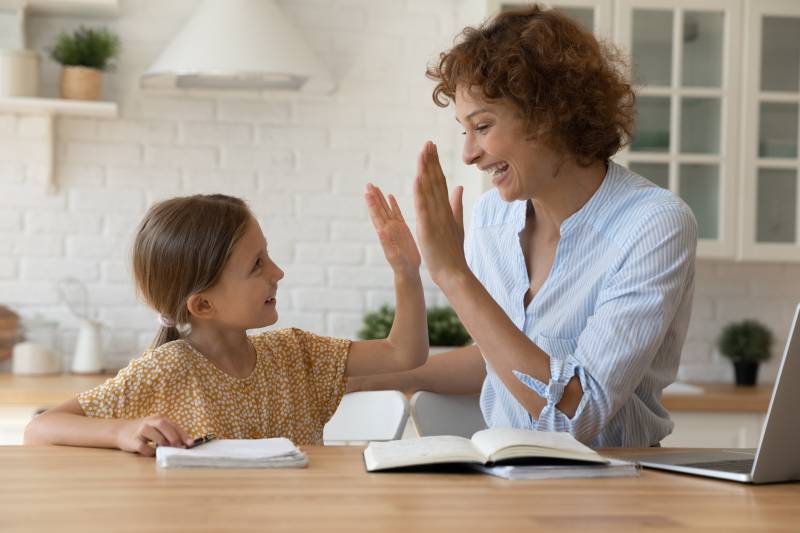 Excited mother high-fives her child