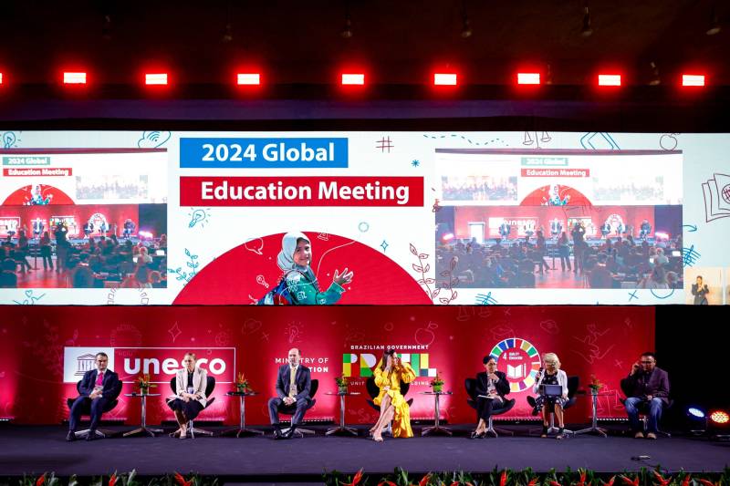 Panelist seated at a stage