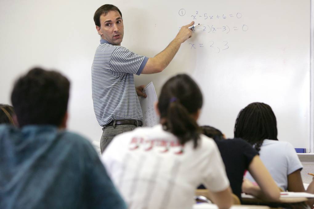 Teacher in front of classroom whiteboard