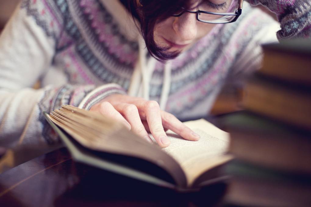 Teenage girl reading old book.