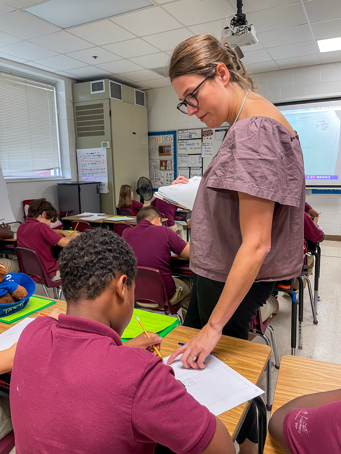 Teacher checks a student's work