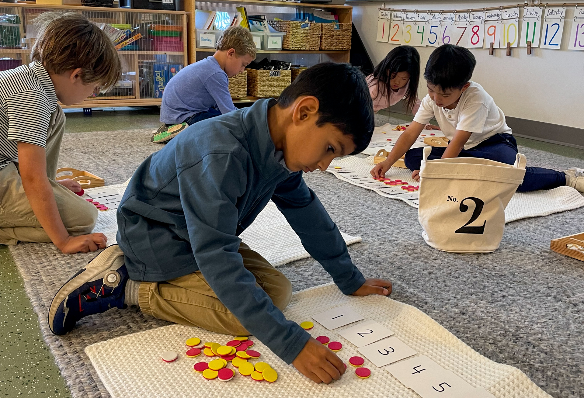 Child sitting on the floor learning math with games