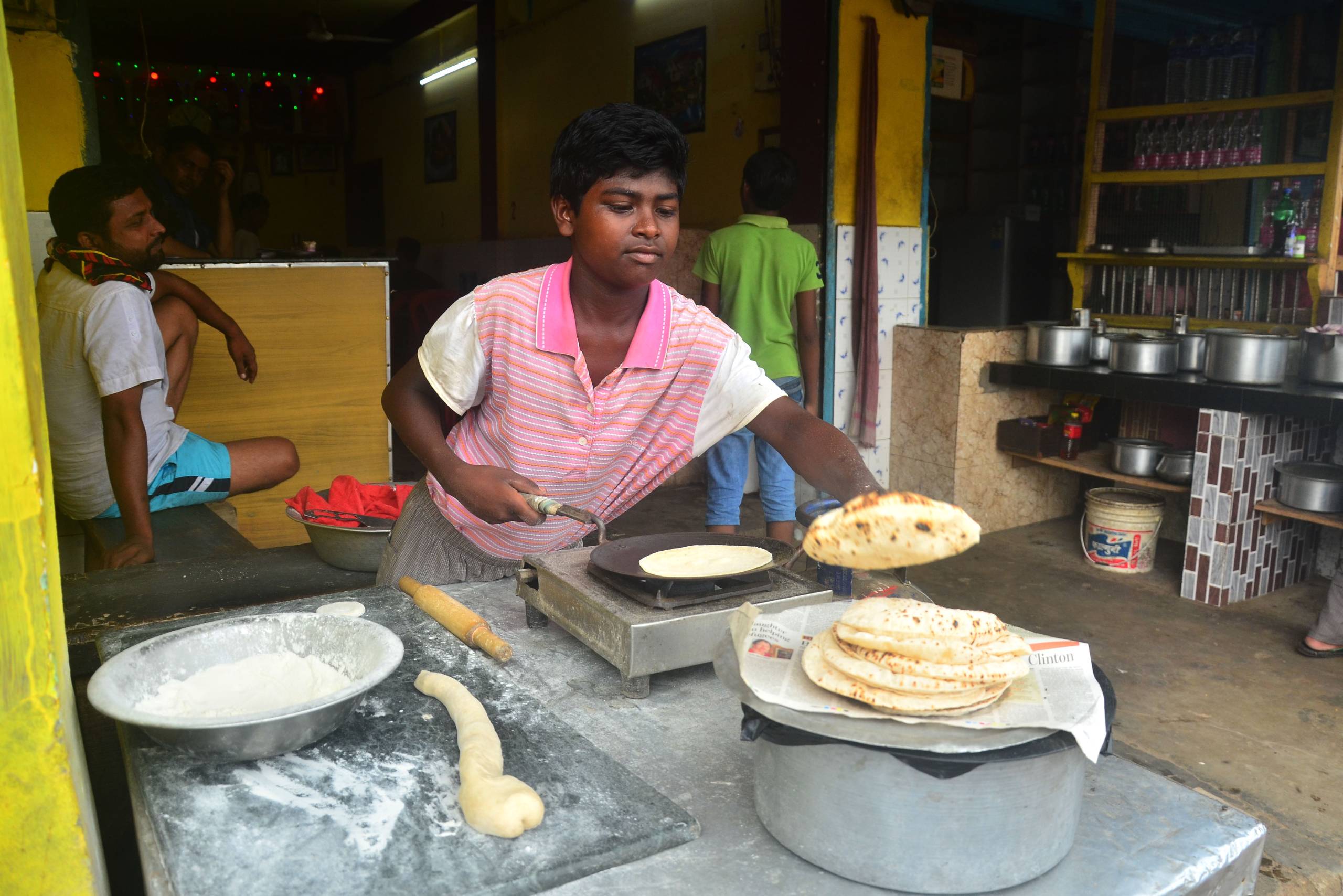 A child makes bread for sale