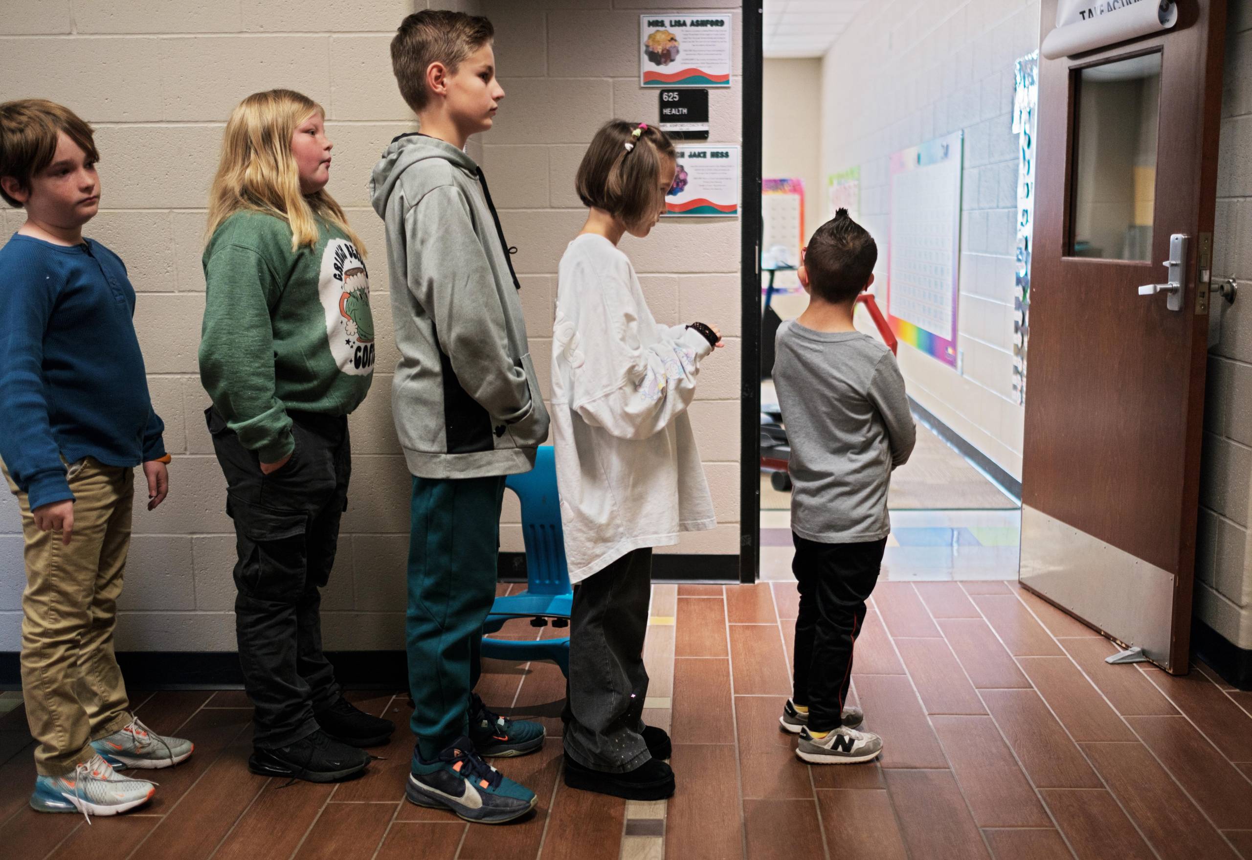 Children standing in a hallway waiting to enter class