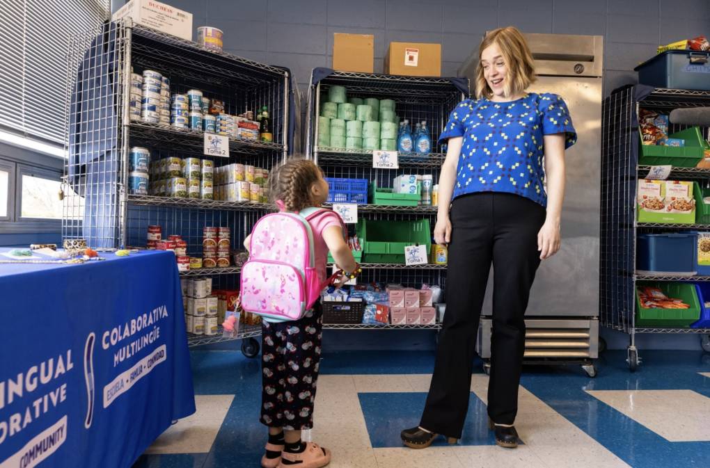 Woman with student in front of pantry