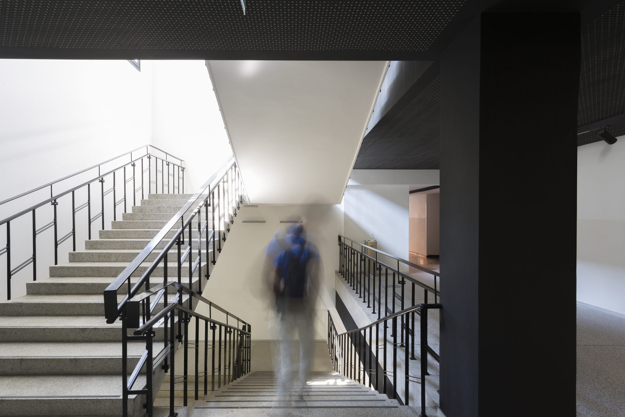 Artistic photo of student fading away from school stairwell