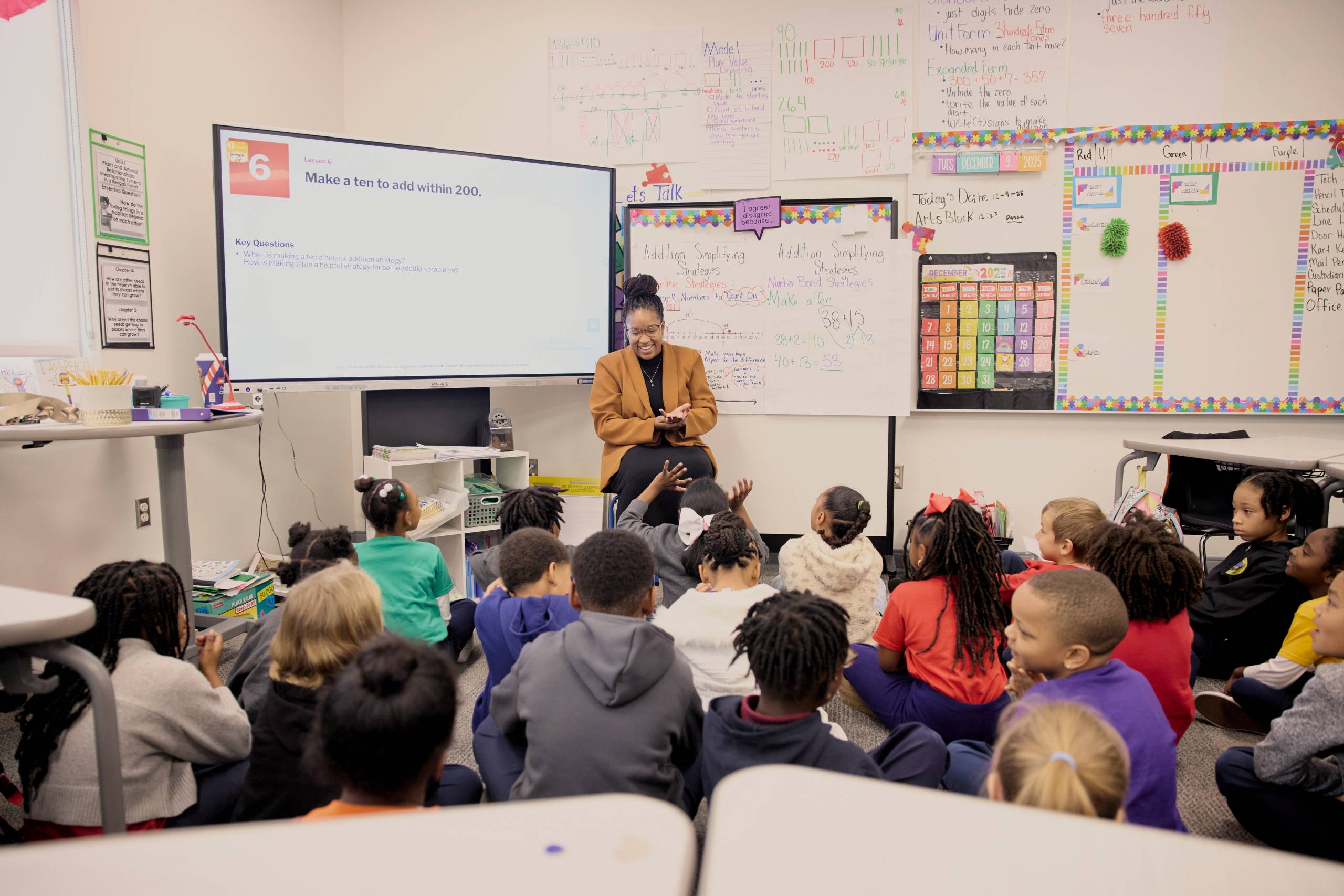 Woman teaches at front of classroom